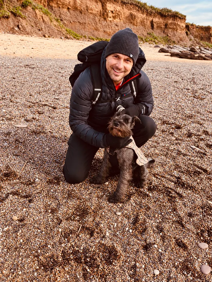Stacey Smith, founder of Answari, with his dog on a beach